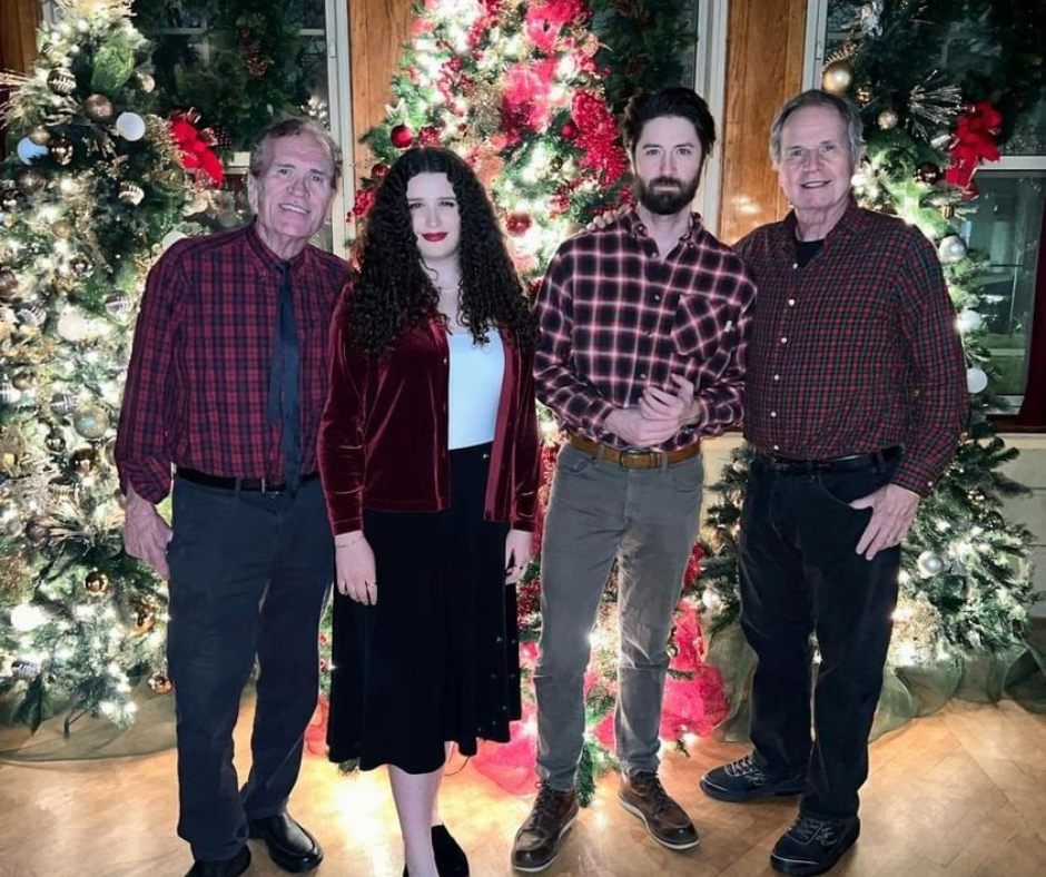 The Dooley Band in front of Christmas trees