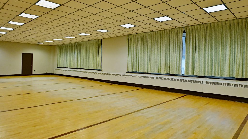 Picture of the room with green curtains closed